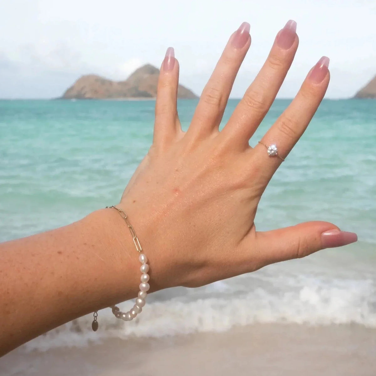 Bracciale e collana a graffetta Rhoni con perla